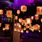 ### ✅ Title Traditional Asian lanterns glowing at night in a vibrant purple-lit courtyard during a cultural celebration