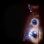 Long exposure light painting swirling around a chrome door handle in a dark room